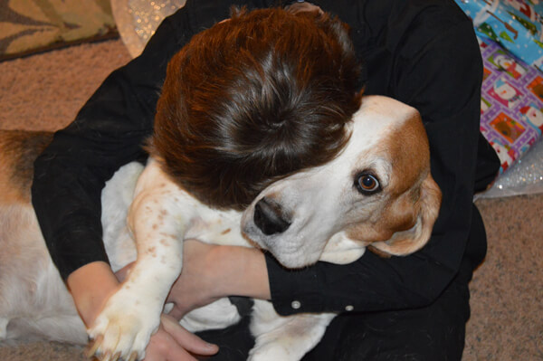 Boy hugging dog